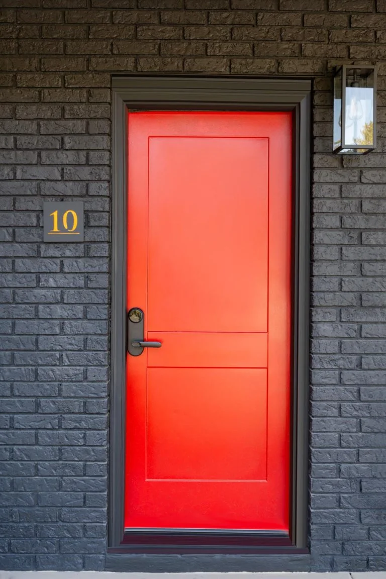 A red door on a brick house.