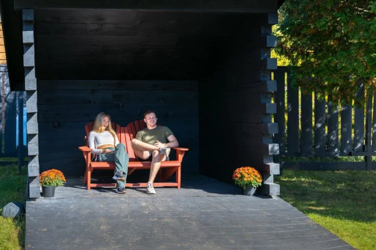 Two people sitting on a bench.