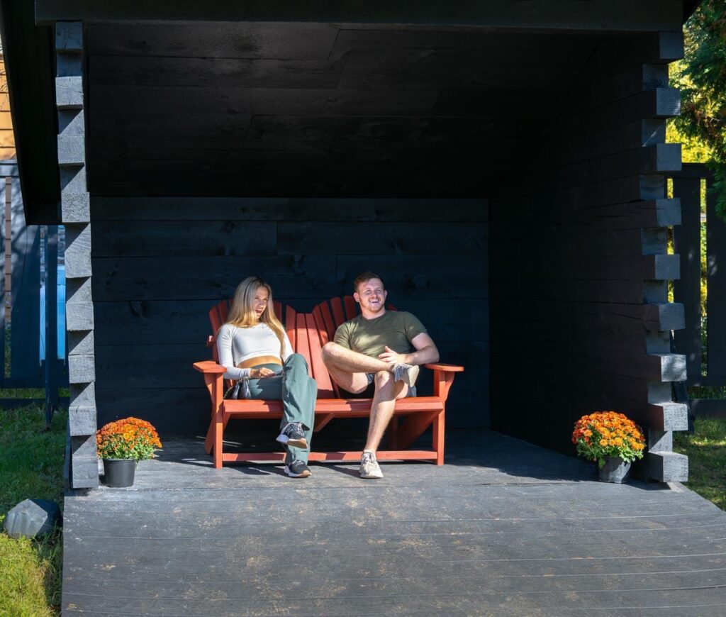 Two people sitting on a bench.