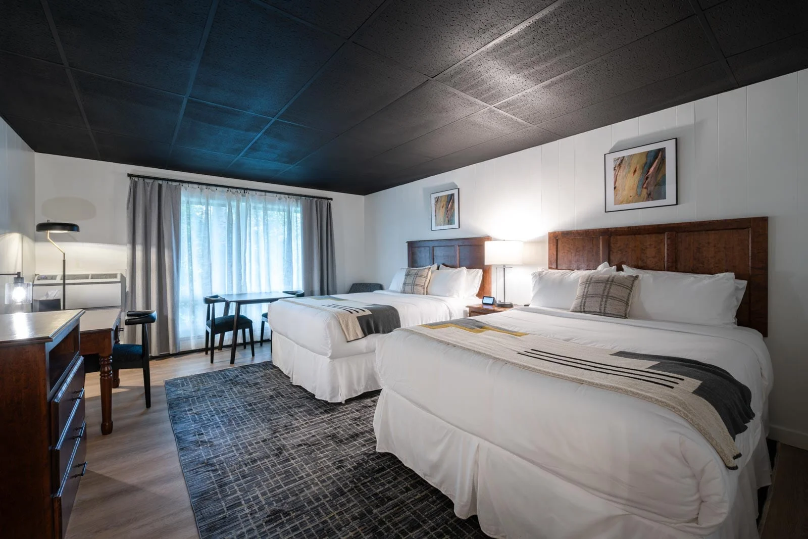 Two beds in a room with a black ceiling.