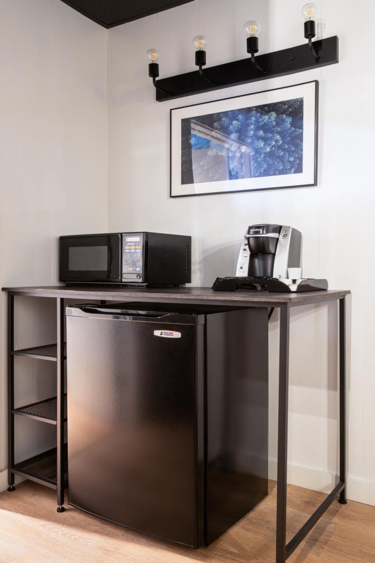 A small kitchen with a microwave and refrigerator.