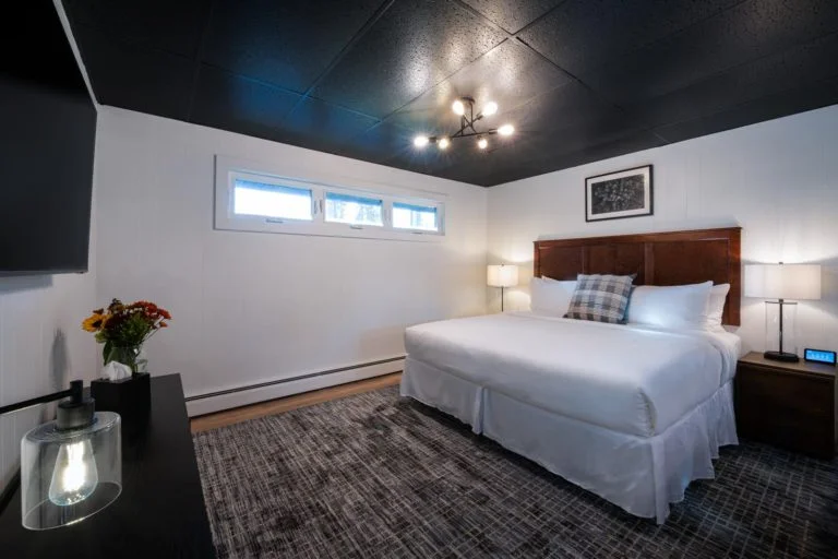 A bed in a room with a black ceiling.