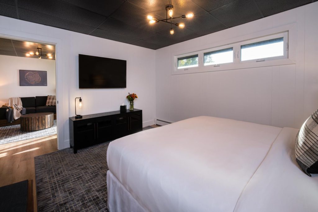 A bedroom with a bed and a tv.
