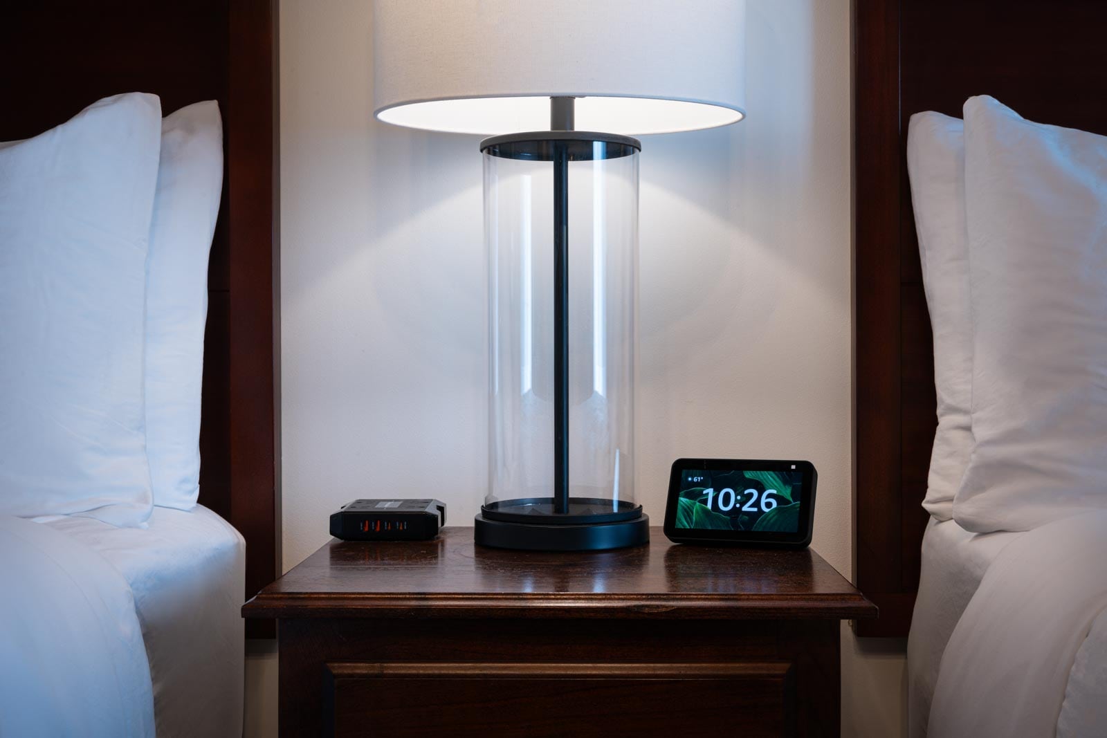 A bedside table with a clock on it.